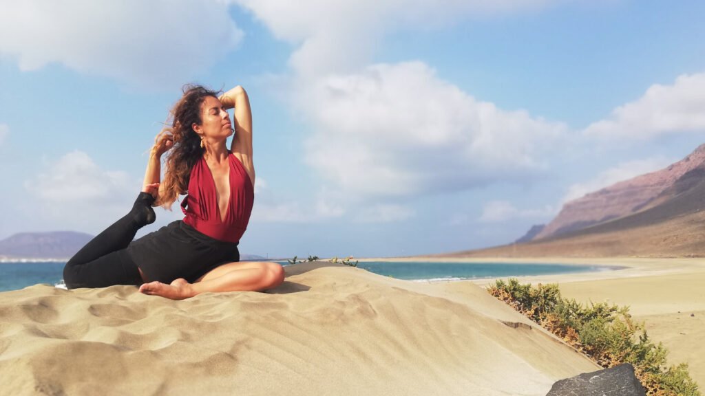 Carmen Mar Yoga pose with Lymphedema on the beach