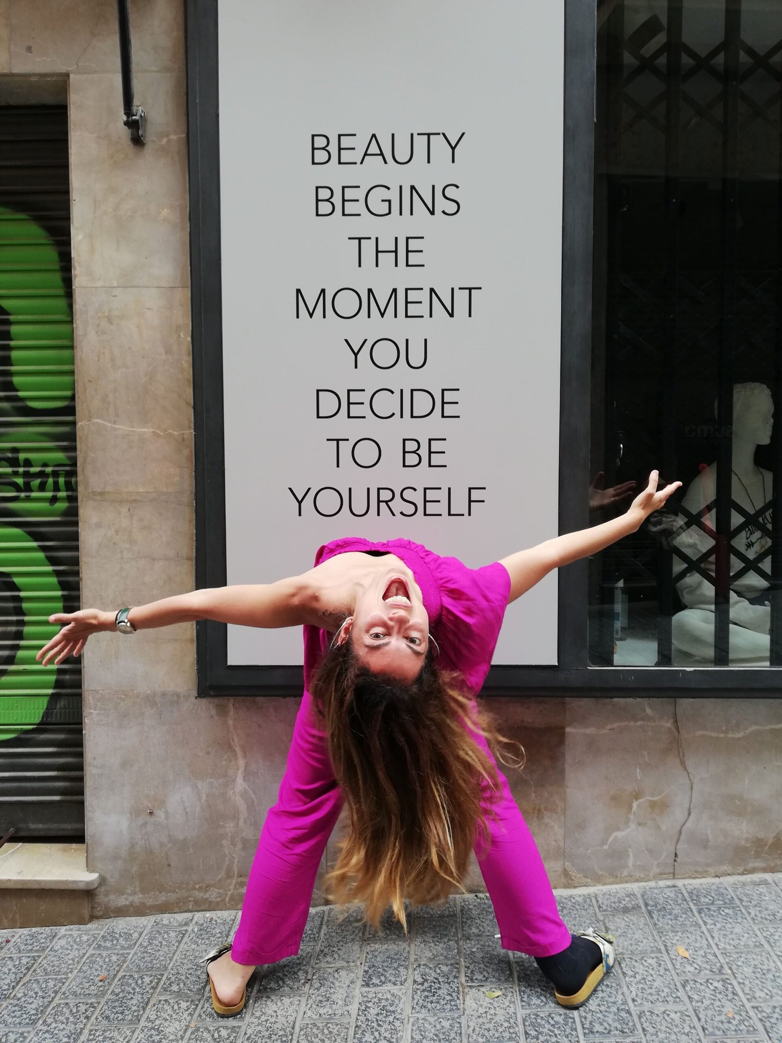 Carmen Mar Dance pose in front of sign Beauty Begins The Moment You Decide To Be Yourself