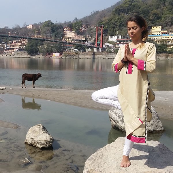 Carmen Mar Vrksasana Treepose in front of Ram Jula Ganges with cow in Rishikesh